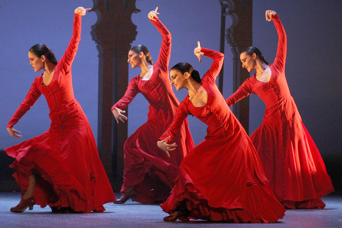 Flamenco dancers performing on a traditional tablao stage in Sevilla.